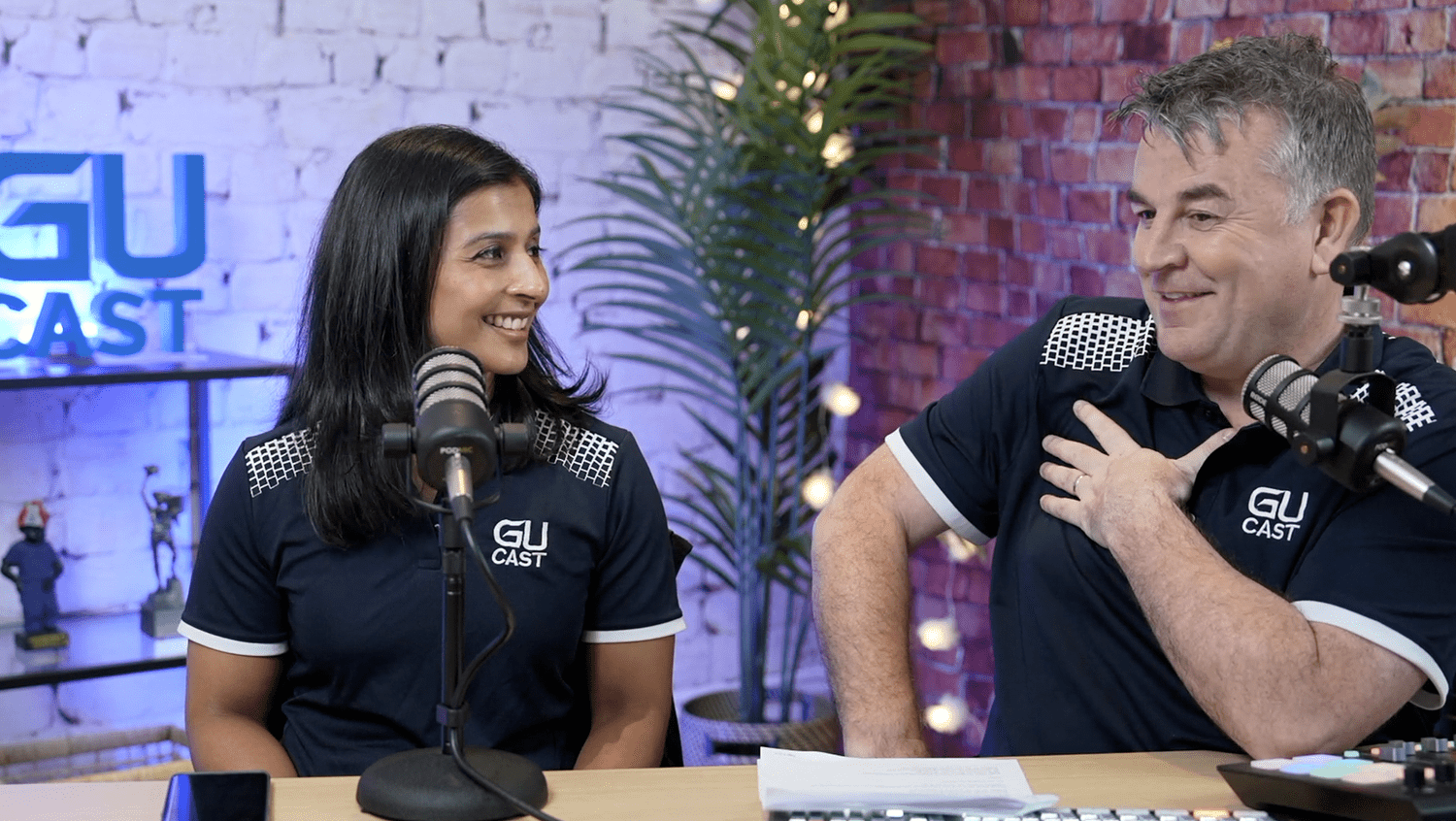 Photo of woman and man in a sound studio making a podcast