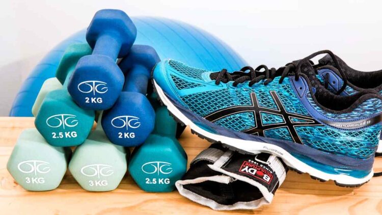 Exercise can help cancer recovery and equipment is simple - here is a pair of blue and black trainer shoes with a selection of dumbbell weights