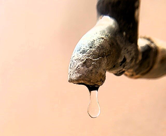 Image of a rusty leaking tap with a drip about to fall