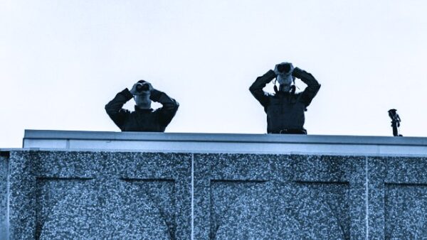 Two people looking through binoculars